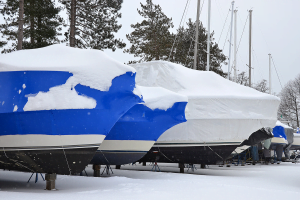 Shrink wrapping your boat with blue shrink wrap to protect it against snow, as seen in this pciture. 