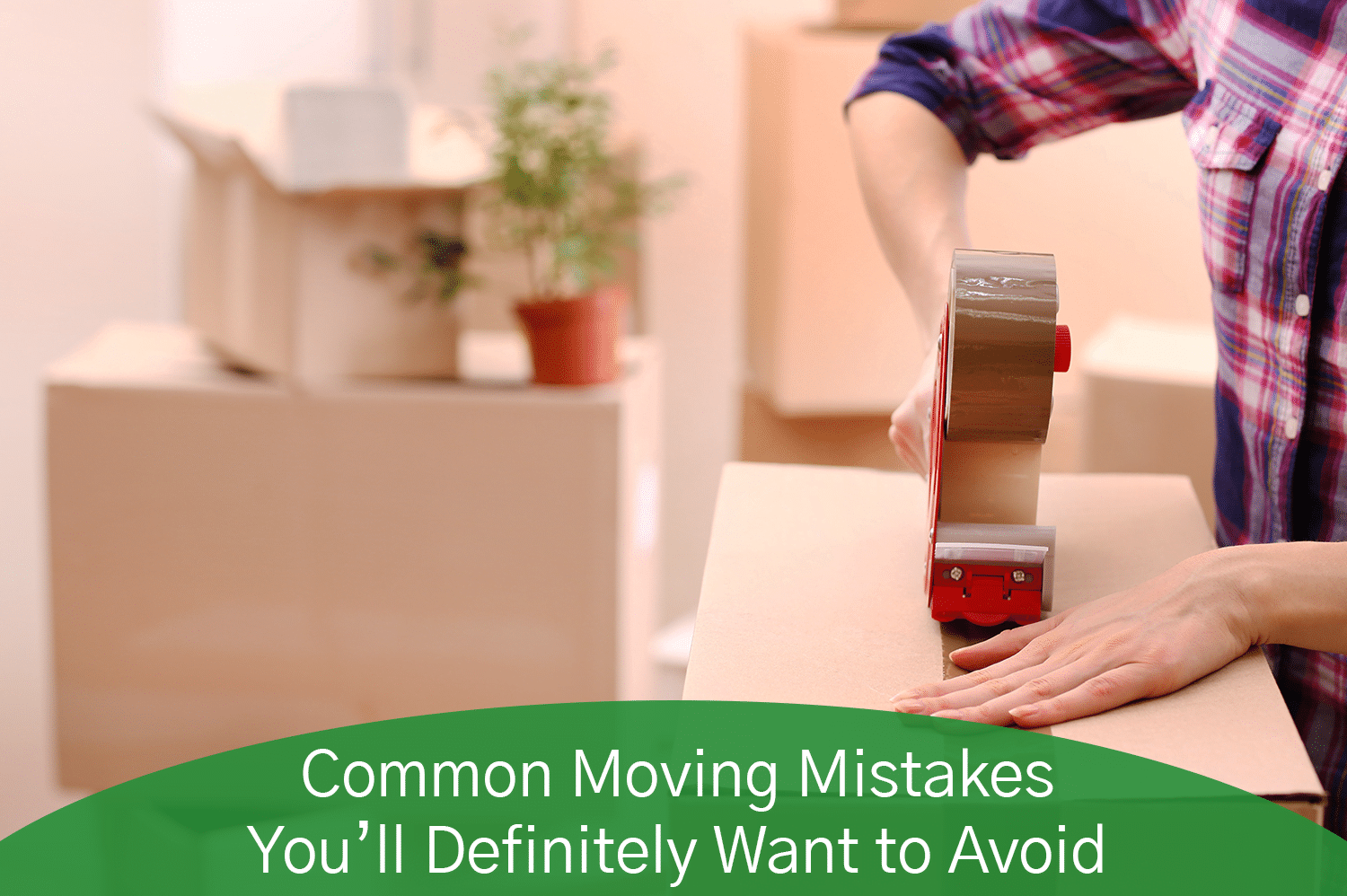 An anonymous person putting packing tape on a moving box.