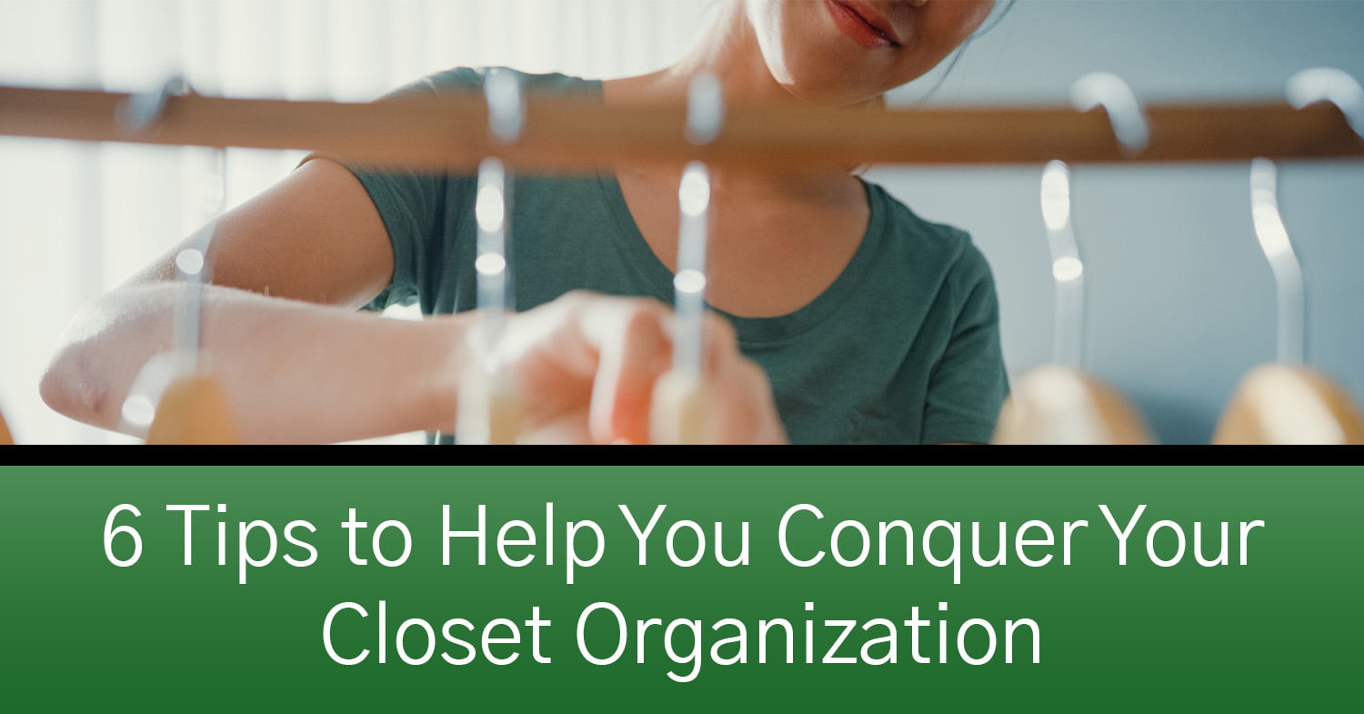 A woman utilizing closet organization tips to transform her closet.