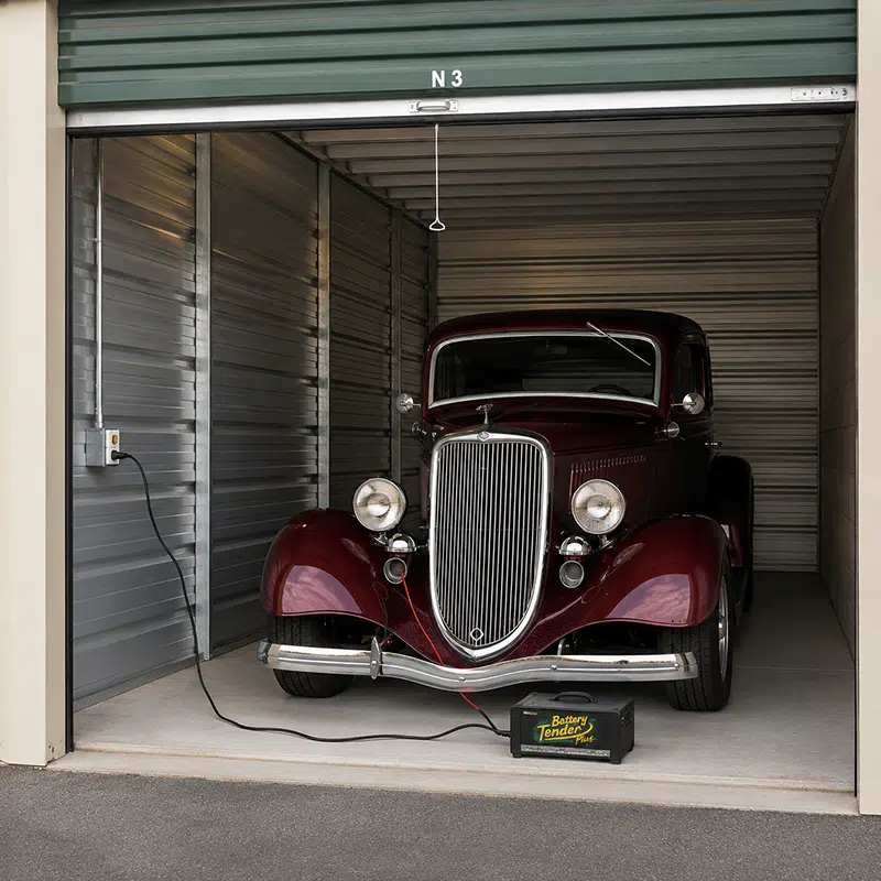 car-storage-unit-with-trickle-charge classic car hooked up to a trickle charge in a powered storage unit