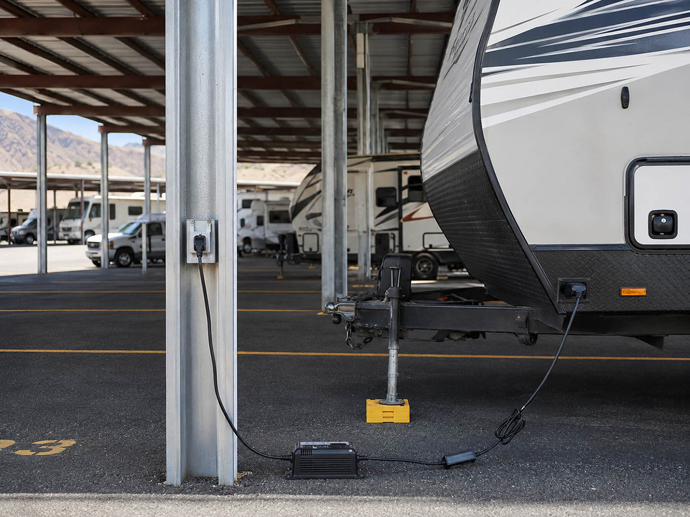 RV Storage with Electrical Hookup Trickle charger connected to a travel trailer in covered RV storage at EZ Access Storage near Wenatchee and East Wenatchee, WA
