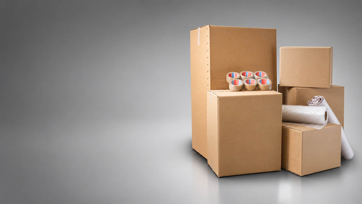 stack of moving boxes and bubble wrap with tape